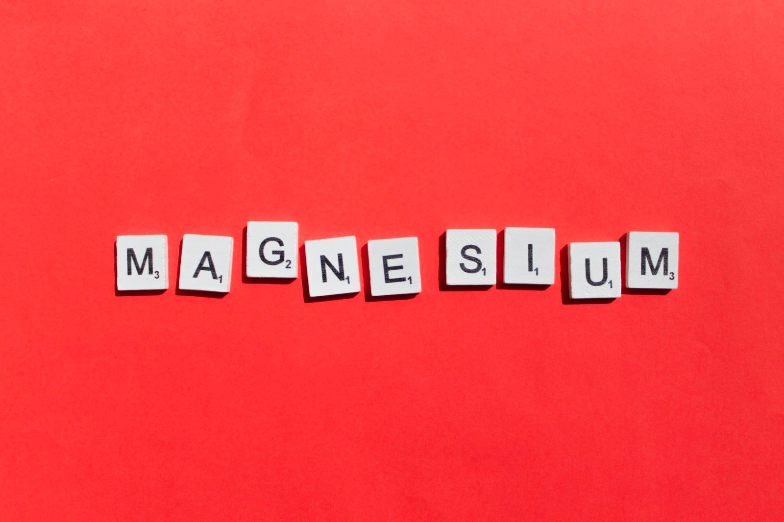 Magnesium scrabble letters word on a red background